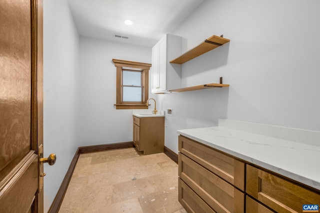 bathroom with visible vents, baseboards, and vanity