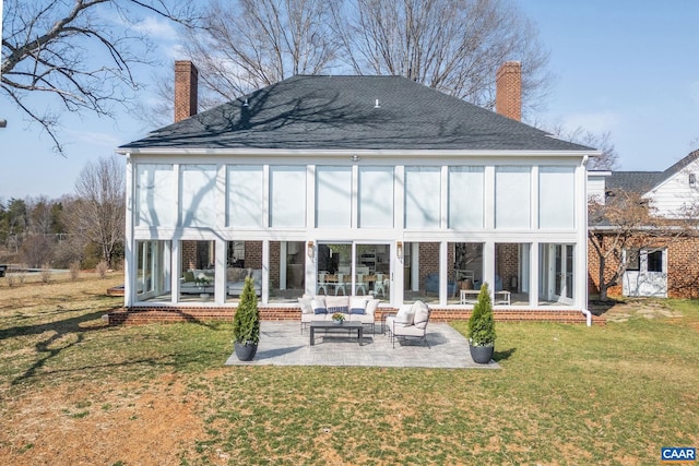 rear view of property featuring a lawn, a patio, a sunroom, an outdoor hangout area, and a chimney