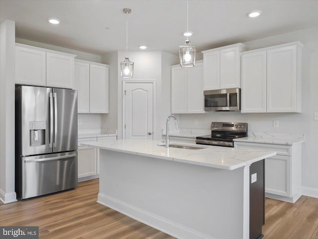 kitchen featuring white cabinetry, light wood-style flooring, appliances with stainless steel finishes, and a sink