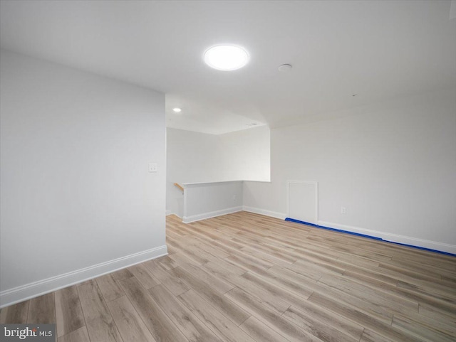 unfurnished room with wood finished floors and baseboards