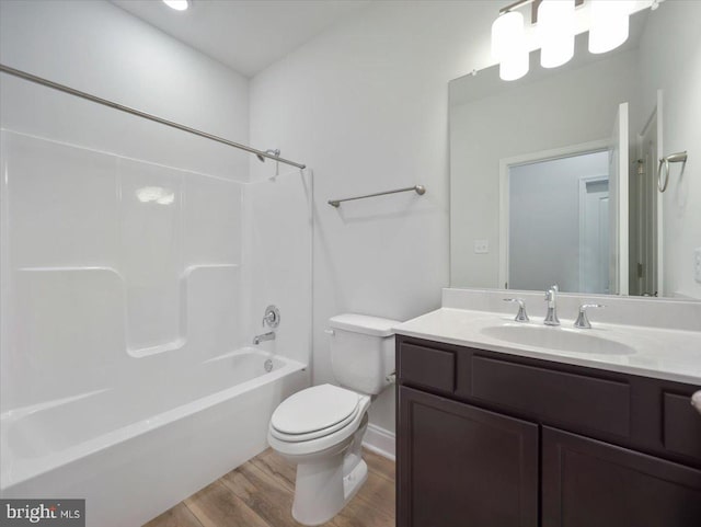 full bathroom with toilet, vanity, shower / bathing tub combination, and wood finished floors