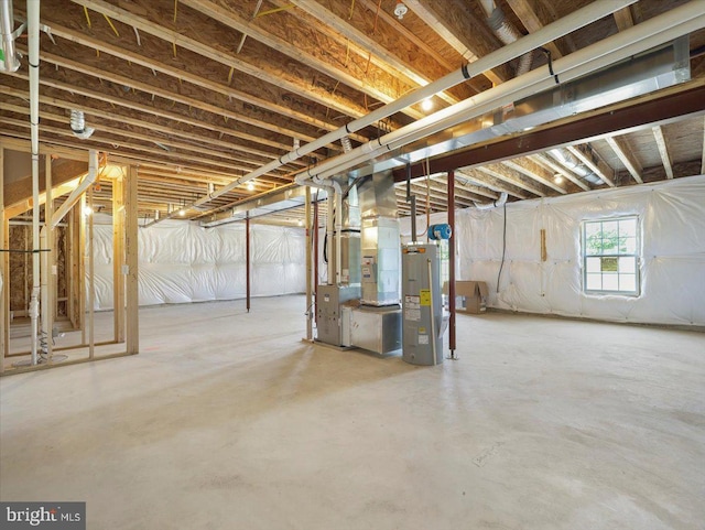 basement featuring heating unit and electric water heater