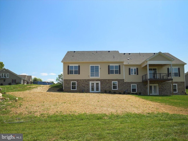 rear view of house with french doors and a yard