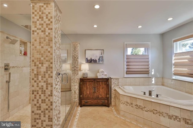 bathroom featuring recessed lighting, a bath, and a shower stall