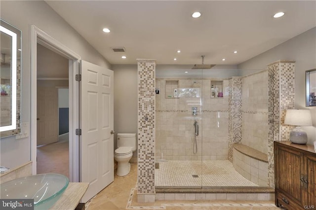 bathroom with visible vents, toilet, recessed lighting, a stall shower, and a sink