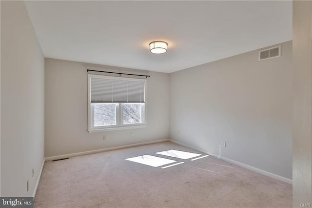 unfurnished room featuring visible vents, baseboards, and carpet flooring