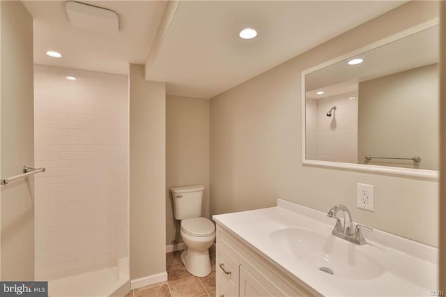 bathroom featuring vanity, recessed lighting, a tile shower, tile patterned flooring, and toilet