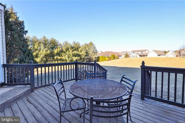 deck with a residential view and outdoor dining space