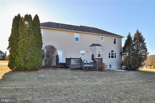 back of property with a lawn and a deck