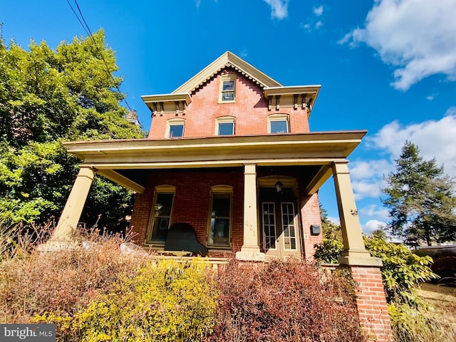 italianate house with brick siding and a porch