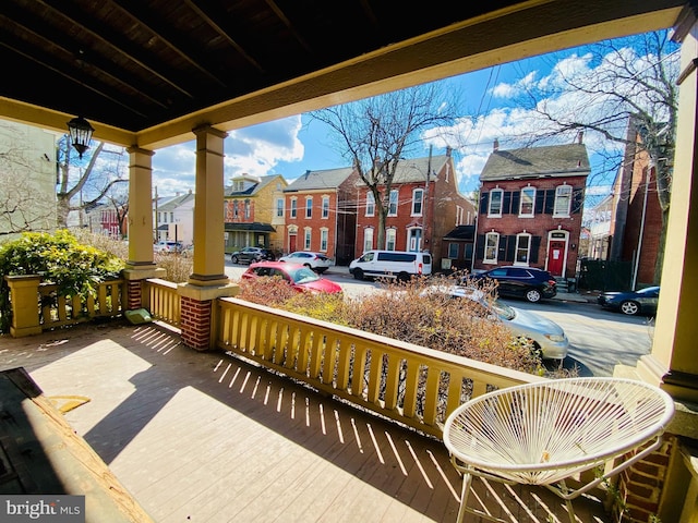 exterior space featuring a porch and a residential view