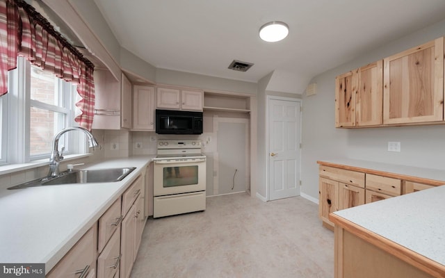 kitchen featuring white electric stove, a sink, light brown cabinetry, light countertops, and black microwave