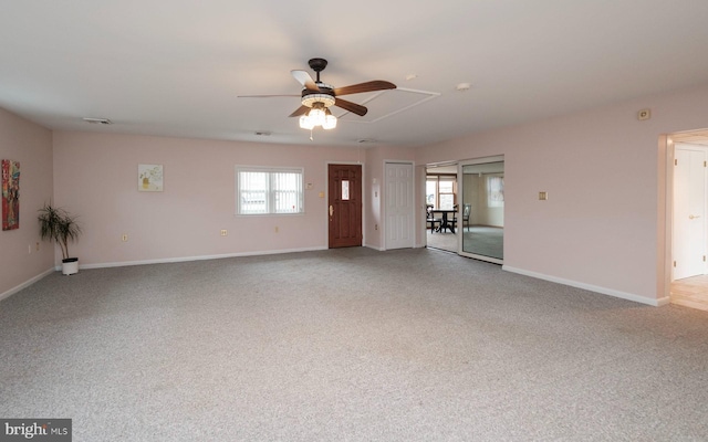 unfurnished room featuring visible vents, baseboards, ceiling fan, attic access, and carpet flooring