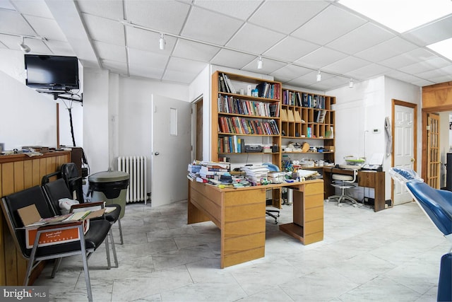 home office featuring radiator and rail lighting