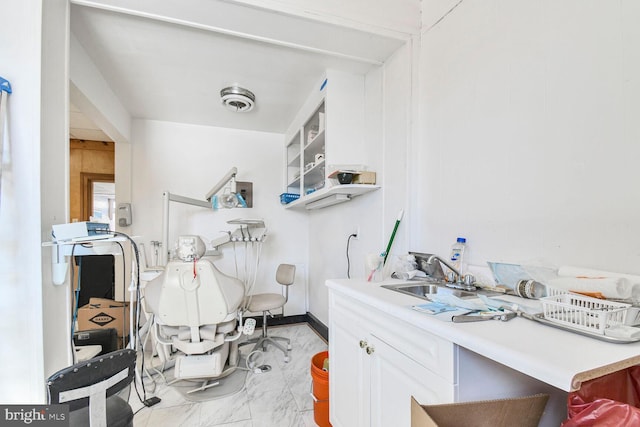 interior space with a sink, visible vents, baseboards, and marble finish floor