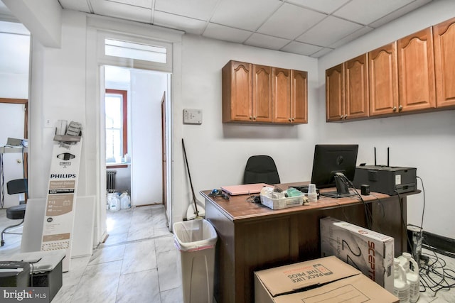 home office with a paneled ceiling and radiator