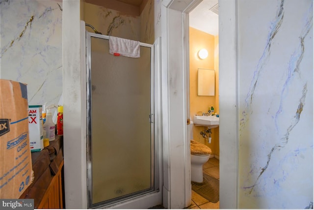 full bath featuring tile patterned flooring, toilet, and a stall shower