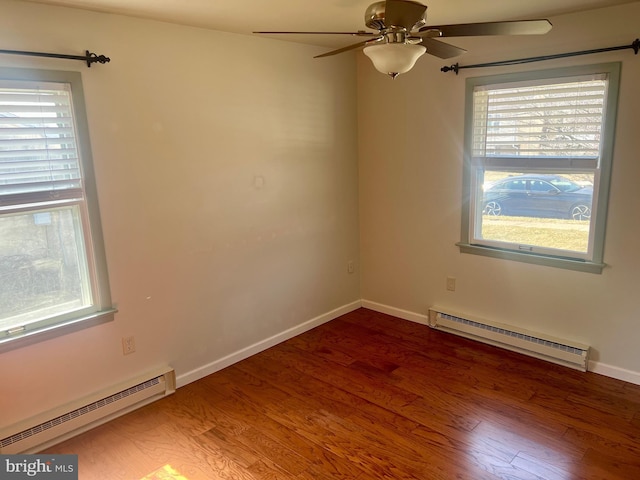 spare room featuring ceiling fan, wood finished floors, baseboards, and a baseboard radiator