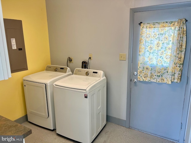 laundry room with electric panel, baseboards, washing machine and dryer, and laundry area