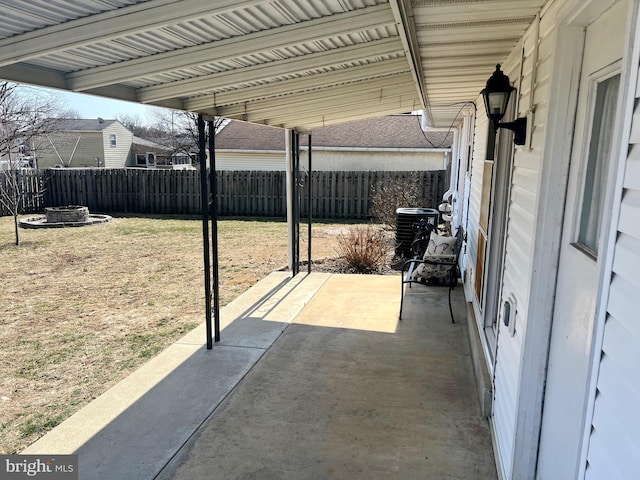 view of patio with central air condition unit and fence