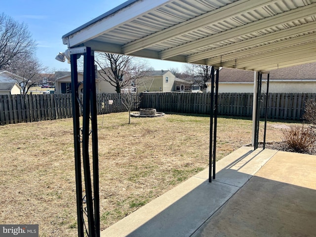 view of yard featuring a patio, a fenced backyard, and an outdoor fire pit