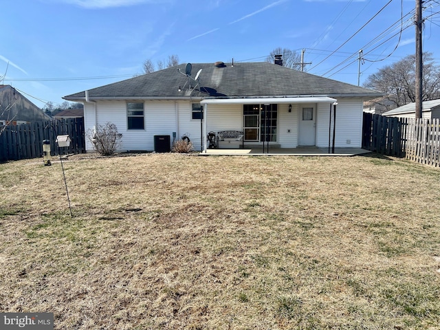 back of house with cooling unit, a patio area, a lawn, and a fenced backyard