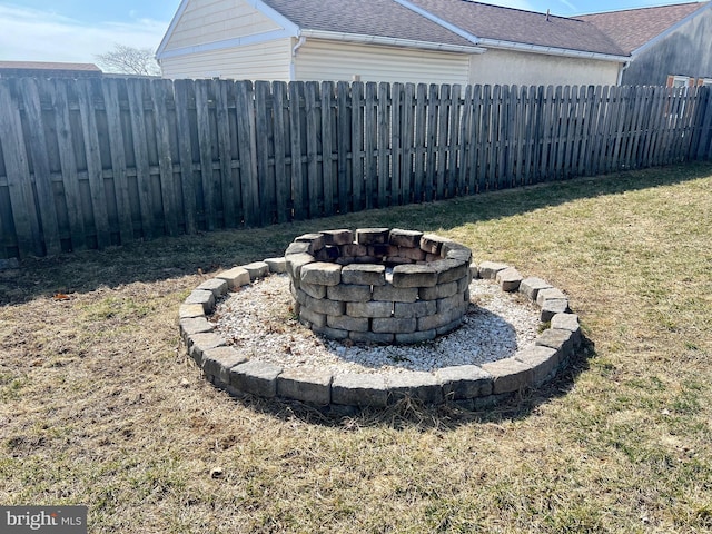 view of yard featuring a fire pit and a fenced backyard