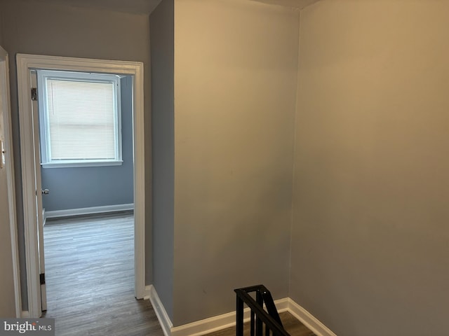 hall featuring dark wood finished floors and baseboards