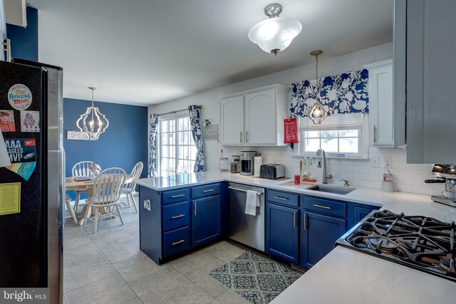 1107 Liberty Ave, Vineland, NJ 08360 - kitchen with blue cabinets, a sink, appliances with stainless steel finishes, a peninsula, and white cabinets