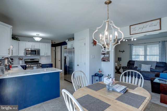 1107 Liberty Ave, Vineland, NJ 08360 - dining area featuring light tile patterned floors and an inviting chandelier