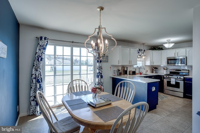 1107 Liberty Ave, Vineland, NJ 08360 - dining area with a chandelier, light tile patterned floors, and a wealth of natural light