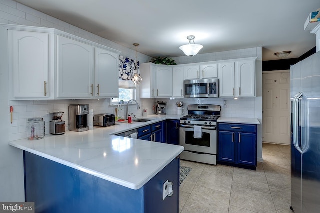 1107 Liberty Ave, Vineland, NJ 08360 - kitchen featuring a sink, white cabinets, blue cabinets, and stainless steel appliances