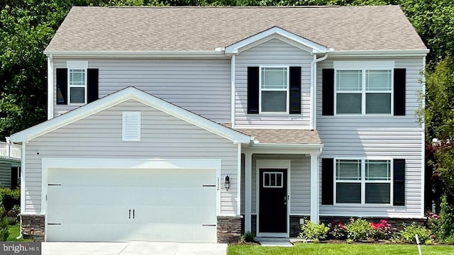 view of front of home with a garage, stone siding, driveway, and a shingled roof