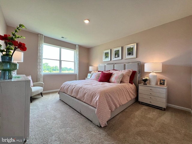 carpeted bedroom featuring visible vents and baseboards