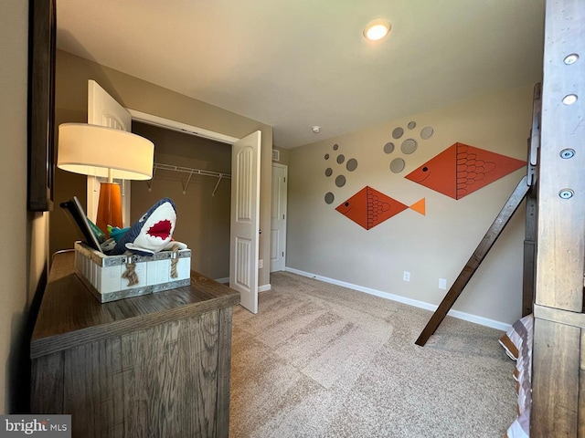 carpeted bedroom featuring a closet and baseboards