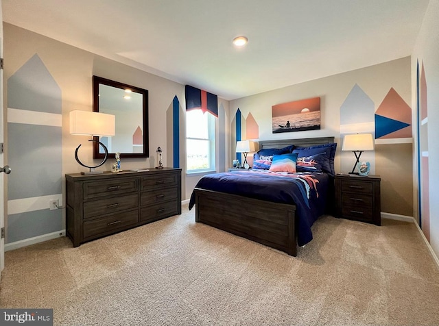 bedroom featuring light colored carpet and baseboards