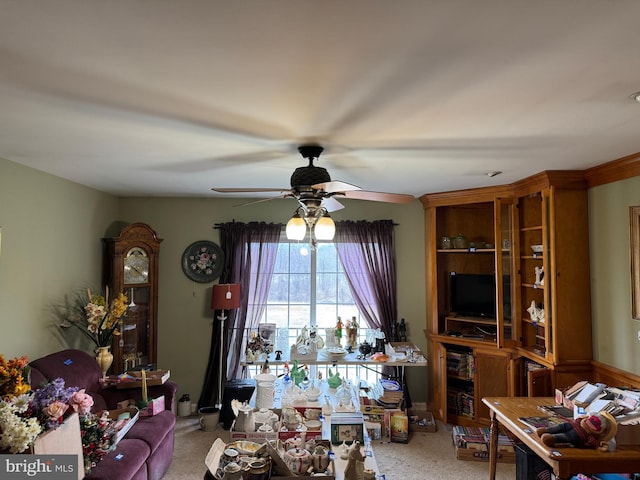 carpeted living area with ceiling fan