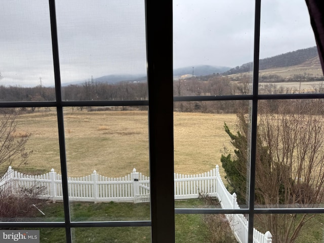 interior space featuring a rural view and fence