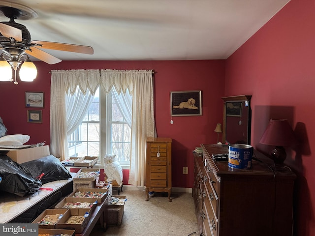 bedroom featuring a ceiling fan, light colored carpet, and baseboards