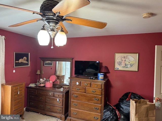 bedroom featuring ceiling fan and light carpet