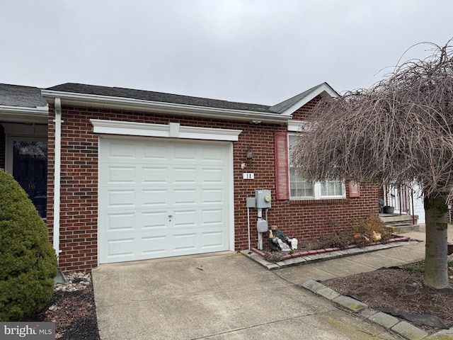 view of property exterior featuring brick siding, driveway, an attached garage, and a shingled roof