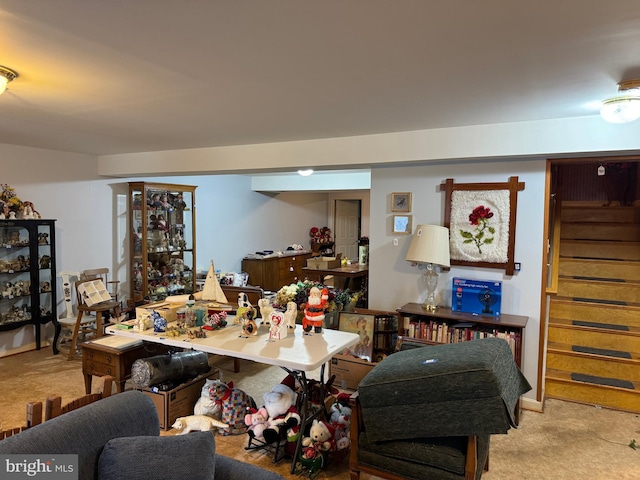 carpeted living area featuring stairway