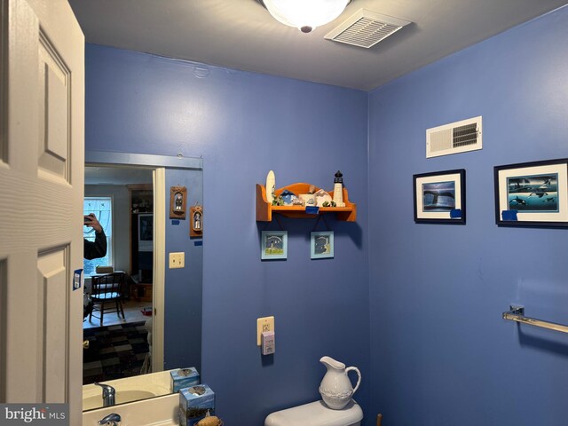 bathroom with visible vents and toilet