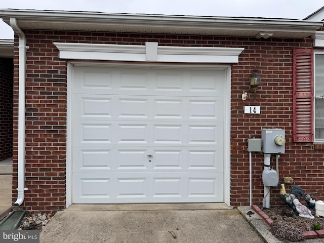 garage featuring concrete driveway