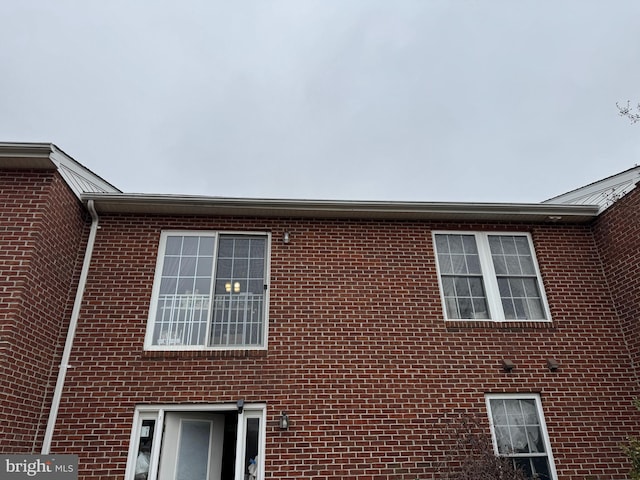 view of property exterior with brick siding