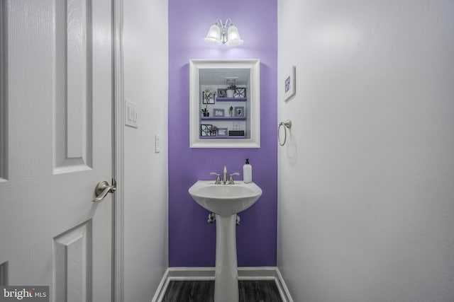 bathroom featuring wood finished floors and baseboards