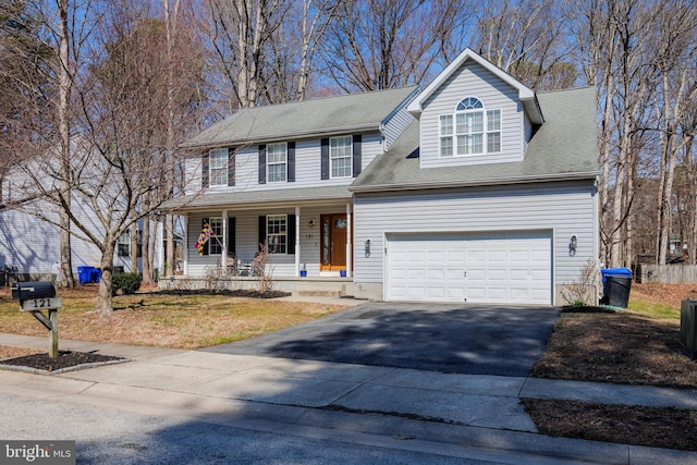 view of front of home featuring a porch, a garage, and aphalt driveway