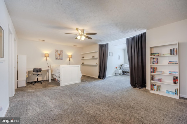 carpeted bedroom featuring a textured ceiling and ceiling fan