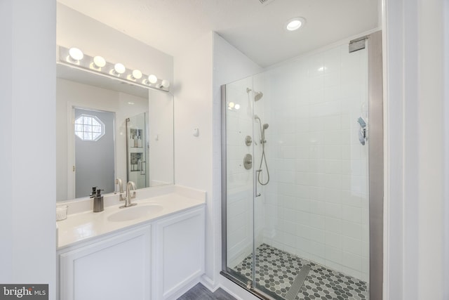 bathroom featuring vanity and a shower stall