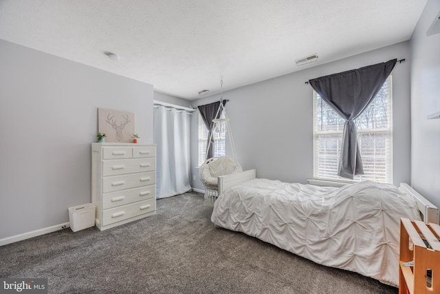 carpeted bedroom with baseboards, visible vents, and a textured ceiling